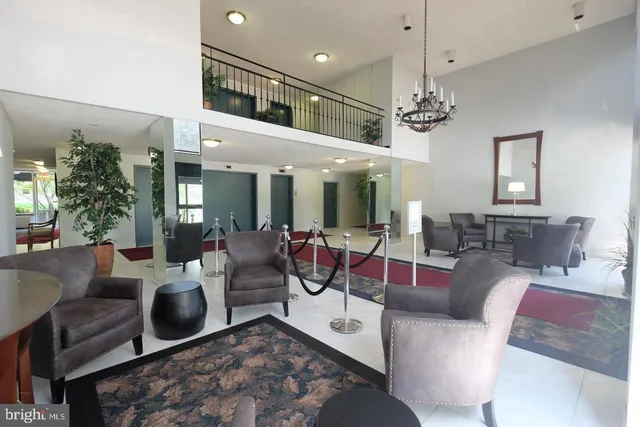 a living room with furniture a chandelier and a chandelier