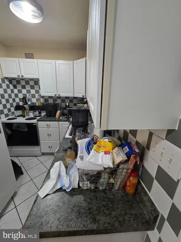 a kitchen with stainless steel appliances kitchen island granite countertop a stove a sink and a microwave