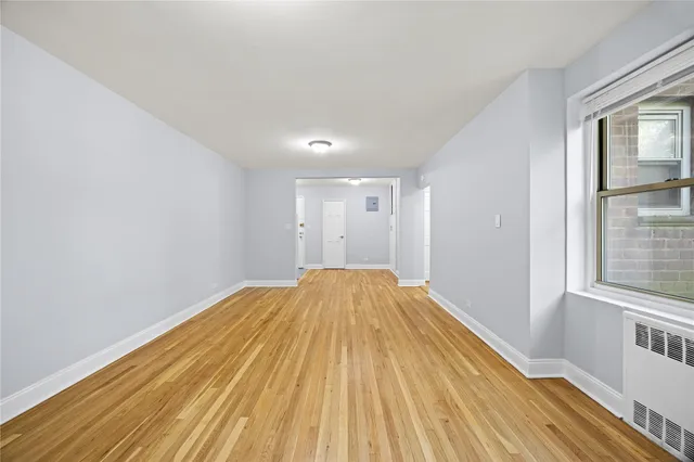 a view of a room with wooden floor and brick walls