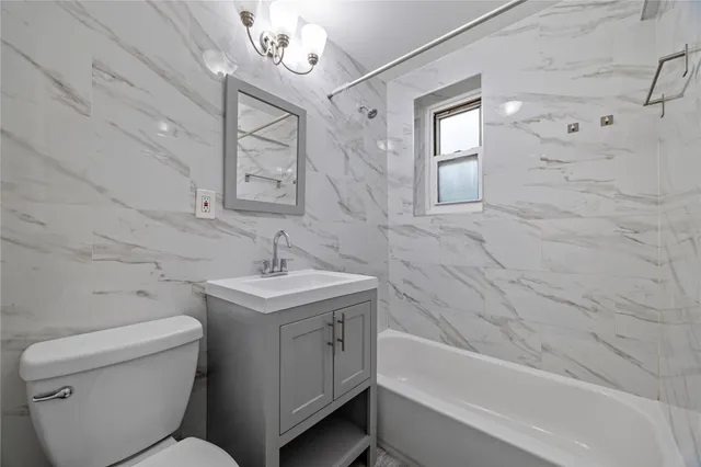 a bathroom with a sink a toilet and bathtub