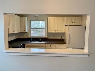 1431 Iyannough Road, Unit 7U Centerville, MA 02632 - Photo 4 of 11 a kitchen with stainless steel appliances granite countertop a sink a refrigerator and cabinets