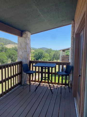 a view of a balcony with wooden floor and outdoor space