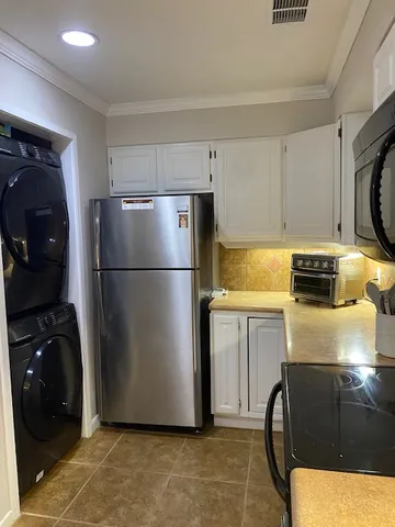 a view of a wooden bench under a large tree