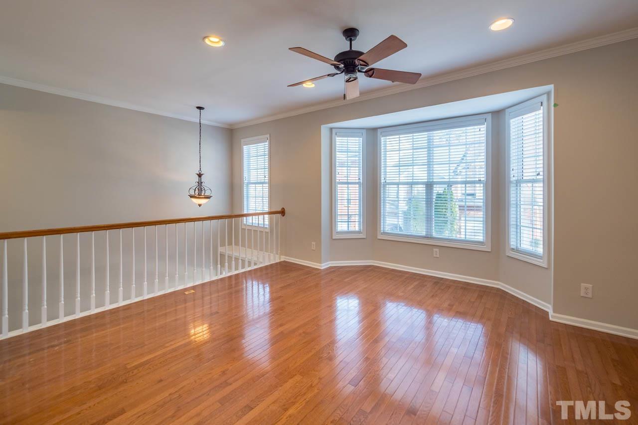 6949 Middleboro Drive Raleigh, NC 27612 - Photo 12 of 35 a view of an empty room with wooden floor and a window