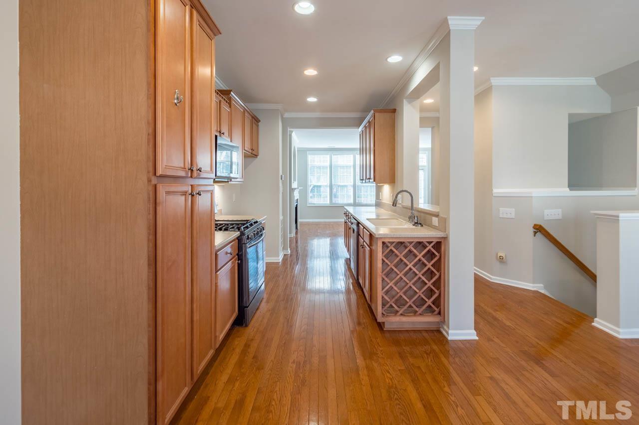 6949 Middleboro Drive Raleigh, NC 27612 - Photo 13 of 35 a view of a hallway view with wooden floor and staircase