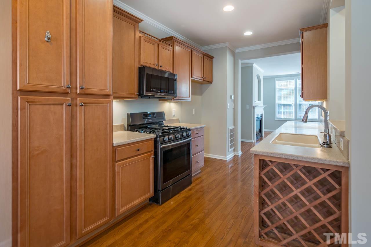 6949 Middleboro Drive Raleigh, NC 27612 - Photo 14 of 35 a kitchen with stainless steel appliances granite countertop a sink stove and refrigerator