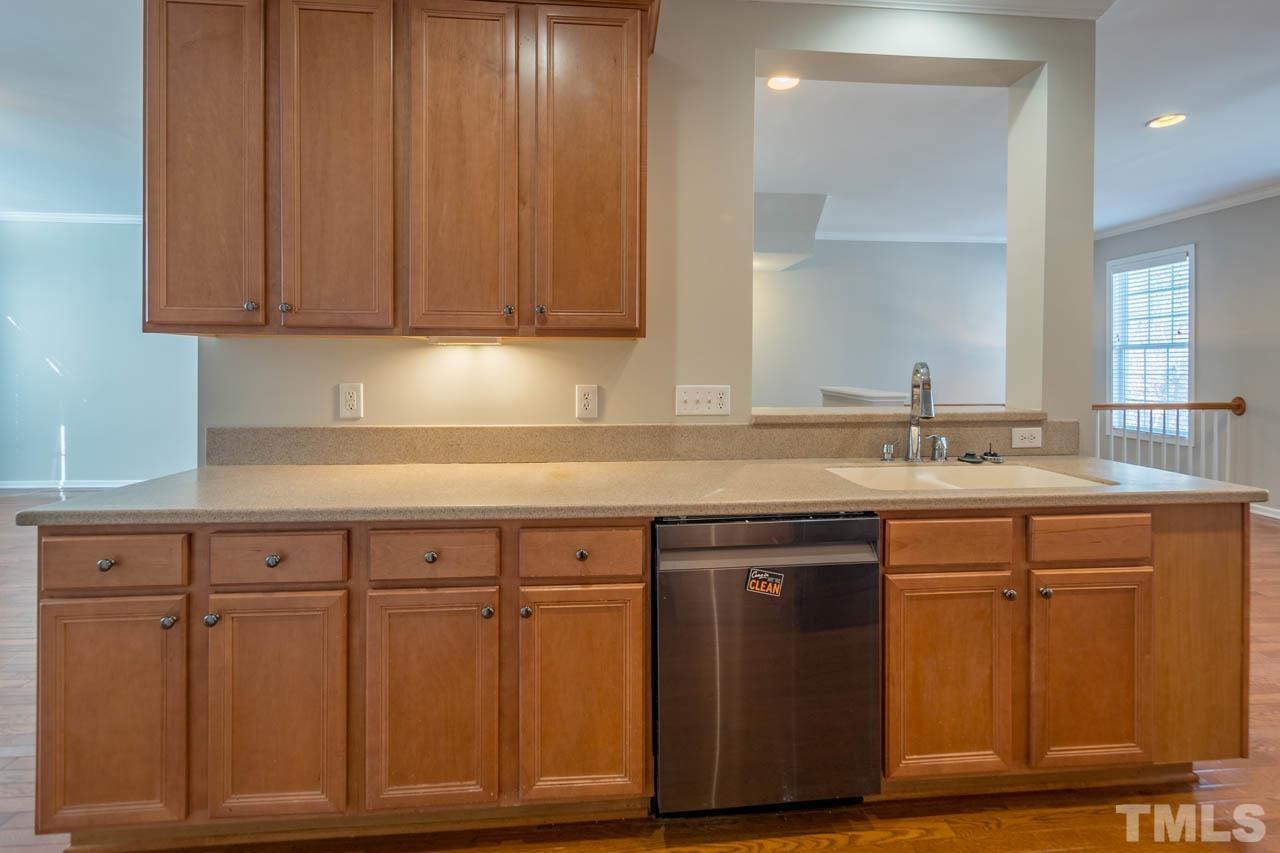 6949 Middleboro Drive Raleigh, NC 27612 - Photo 16 of 35 a sink with wooden cabinets