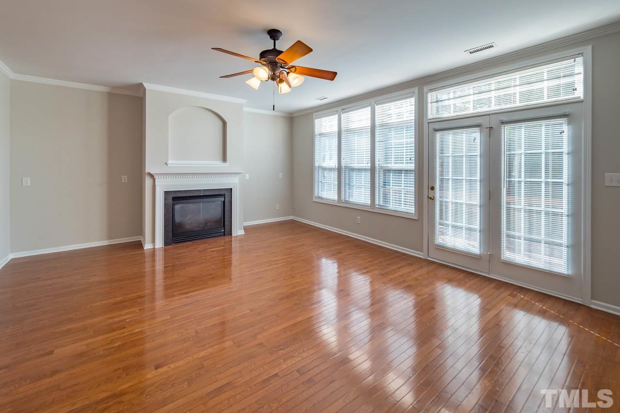 6949 Middleboro Drive Raleigh, NC 27612 - Photo 20 of 35 a view of an empty room with a window and wooden floor