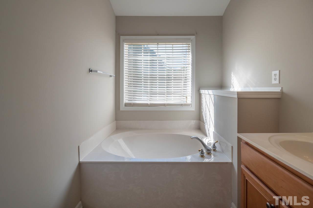 6949 Middleboro Drive Raleigh, NC 27612 - Photo 33 of 35 a bathroom with a bathtub and a sink