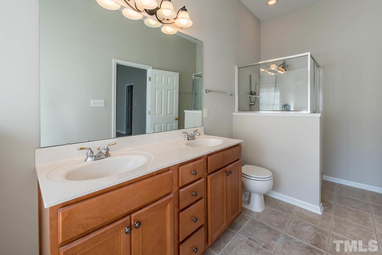 6949 Middleboro Drive Raleigh, NC 27612 - Photo 34 of 35 a bathroom with a toilet sink and mirror