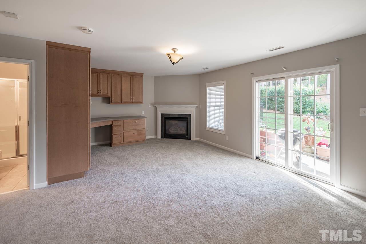 6949 Middleboro Drive Raleigh, NC 27612 - Photo 6 of 35 a view of empty room with a fireplace and a window