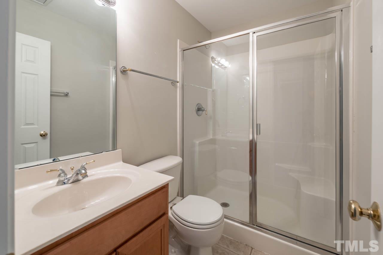 6949 Middleboro Drive Raleigh, NC 27612 - Photo 10 of 35 a bathroom with a sink toilet and shower