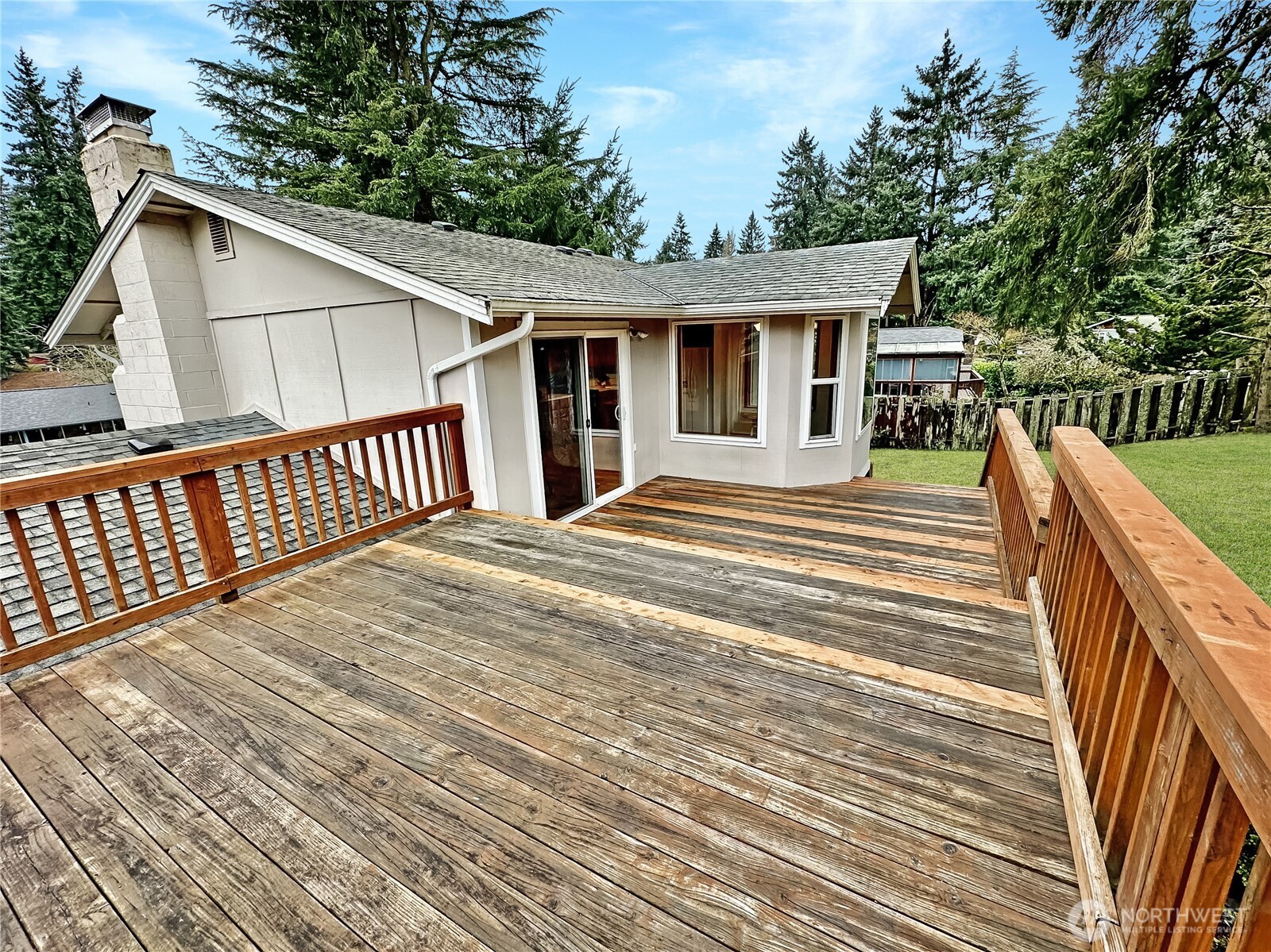 7910 Husky Way Southeast Lacey, WA 98503 - Photo 11 of 36 a view of backyard with deck and wooden floor
