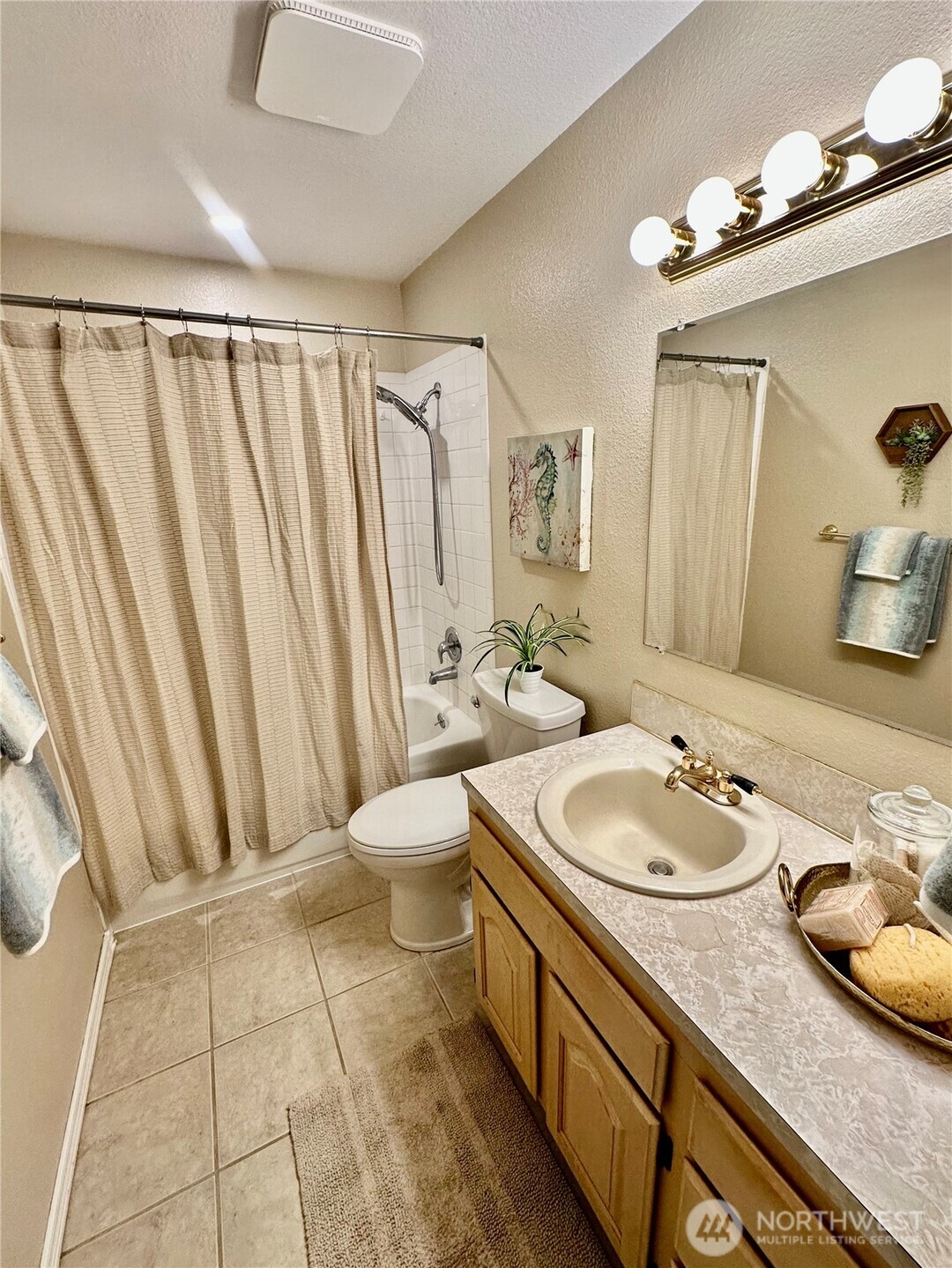 7910 Husky Way Southeast Lacey, WA 98503 - Photo 13 of 36 a bathroom with a granite countertop sink and a mirror