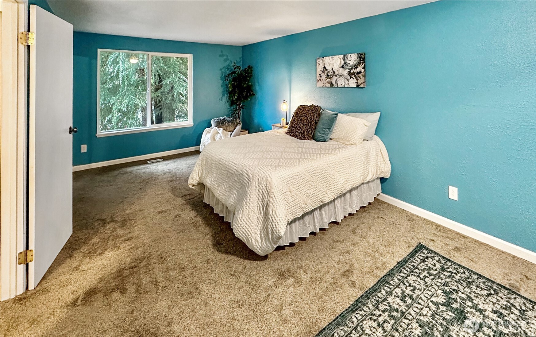 7910 Husky Way Southeast Lacey, WA 98503 - Photo 15 of 36 a bedroom with a bed and a painting on the wall