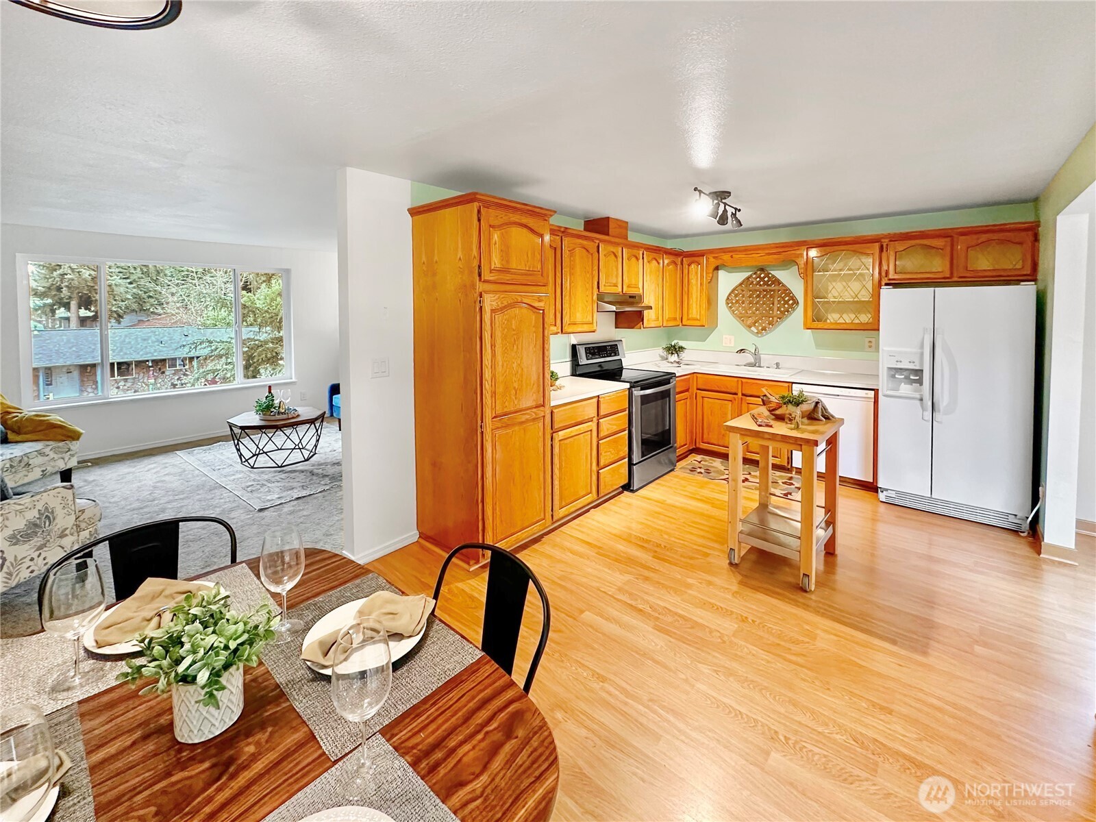 7910 Husky Way Southeast Lacey, WA 98503 - Photo 7 of 36 a living room with furniture and a table with kitchen view