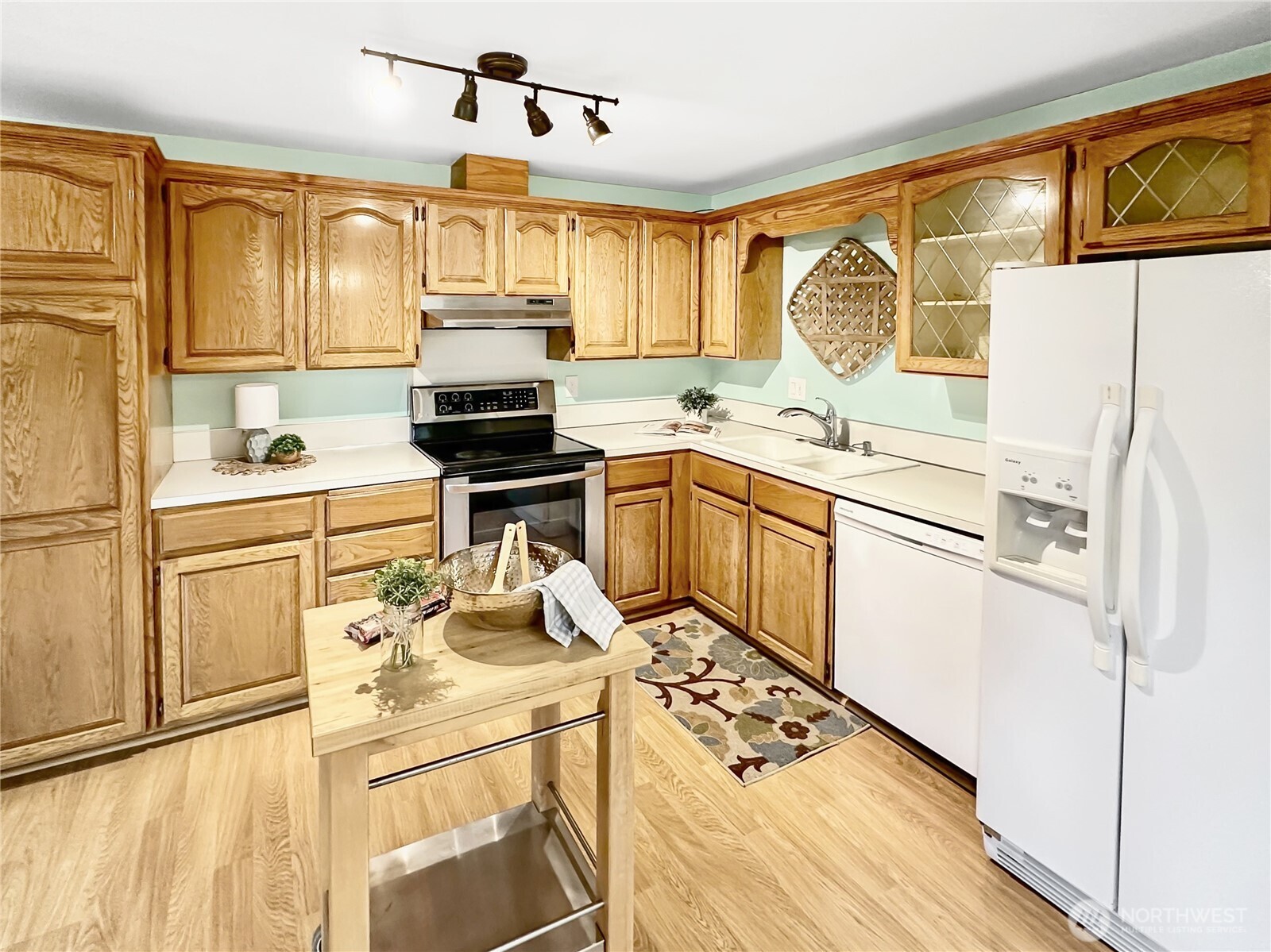 7910 Husky Way Southeast Lacey, WA 98503 - Photo 8 of 36 a kitchen with granite countertop a sink appliances cabinets and furniture