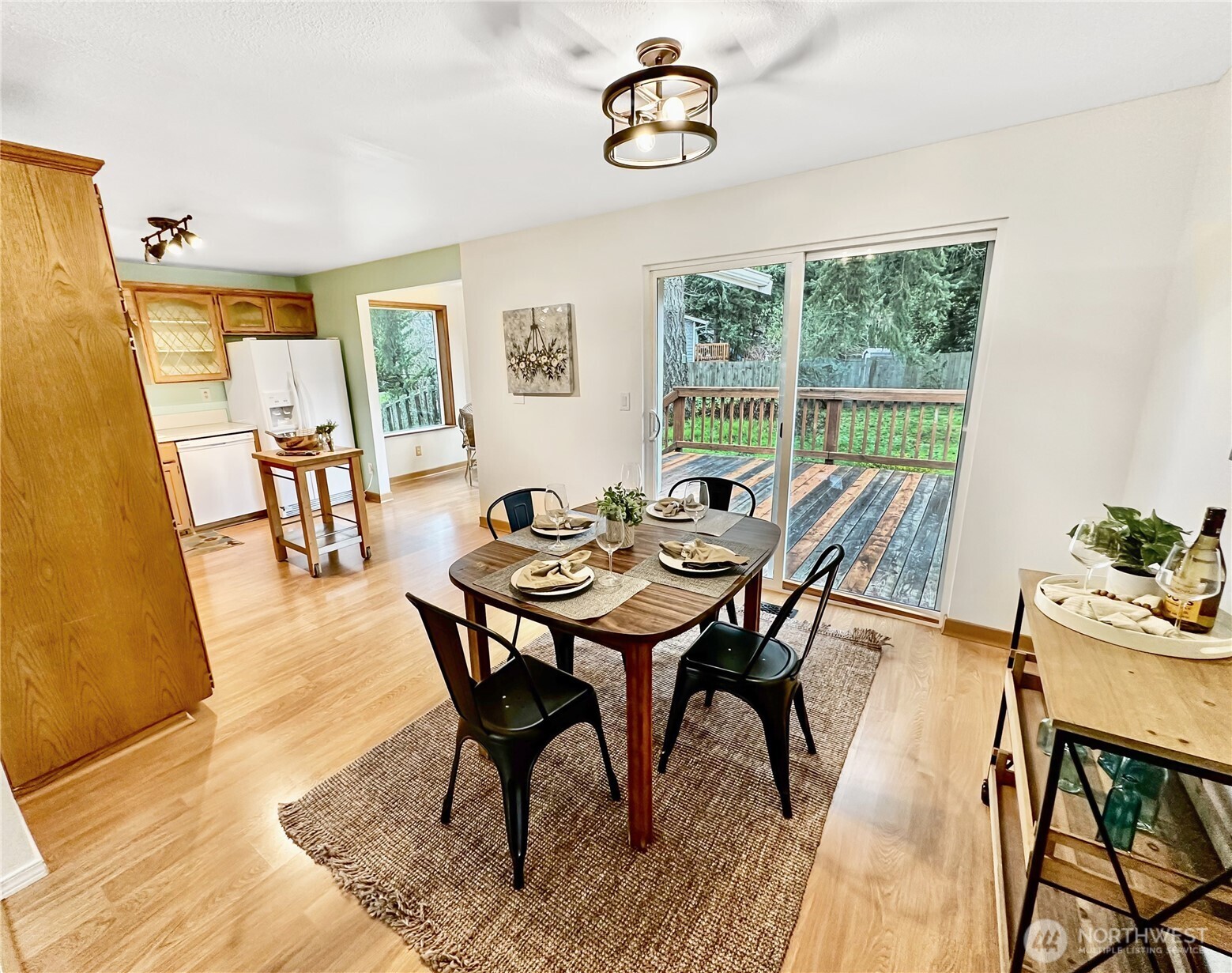 7910 Husky Way Southeast Lacey, WA 98503 - Photo 10 of 36 a dining room with furniture a rug and a large window