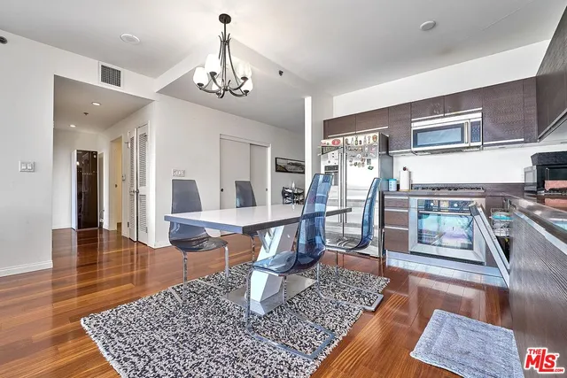 a living room with dining room and wooden floor