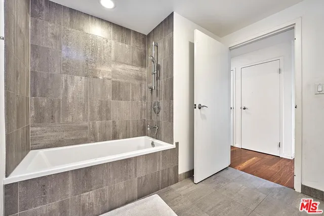 a bathroom with a bathtub and shower