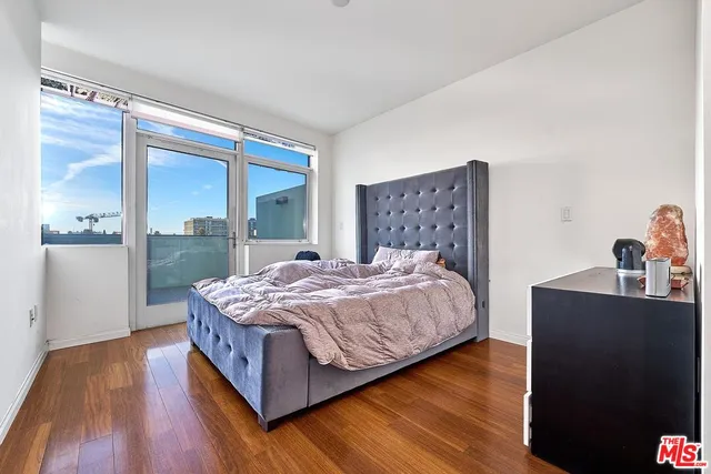 a bedroom with a bed and a large window