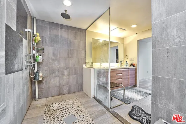 a bathroom with a glass shower door and a sink