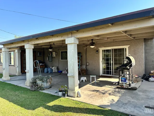a view of a house with backyard porch and furniture