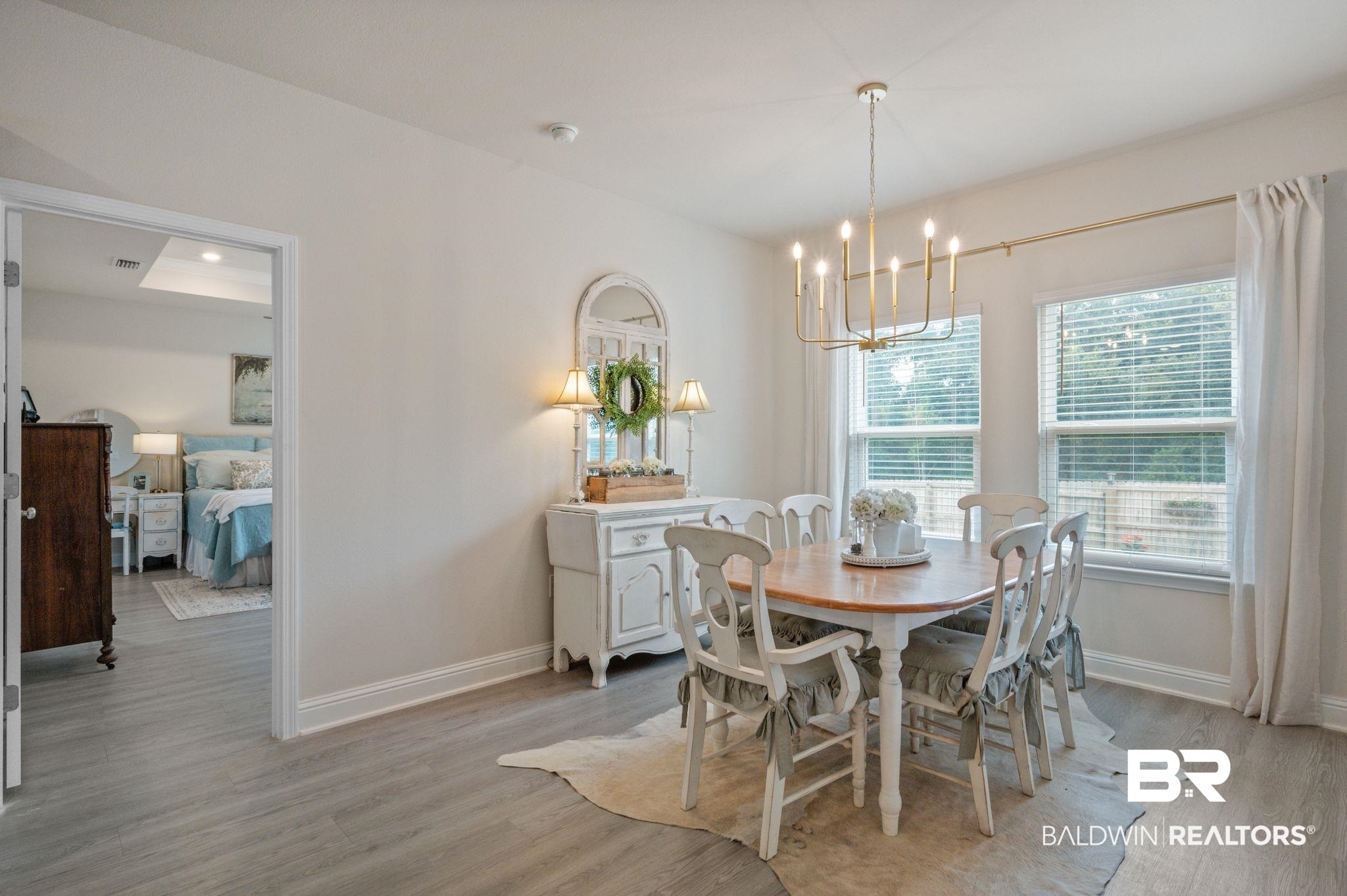 681 Calibre Street Fairhope, AL 36532 - Photo 28 of 56 Dining area with a chandelier and light hardwood / wood-style floors
