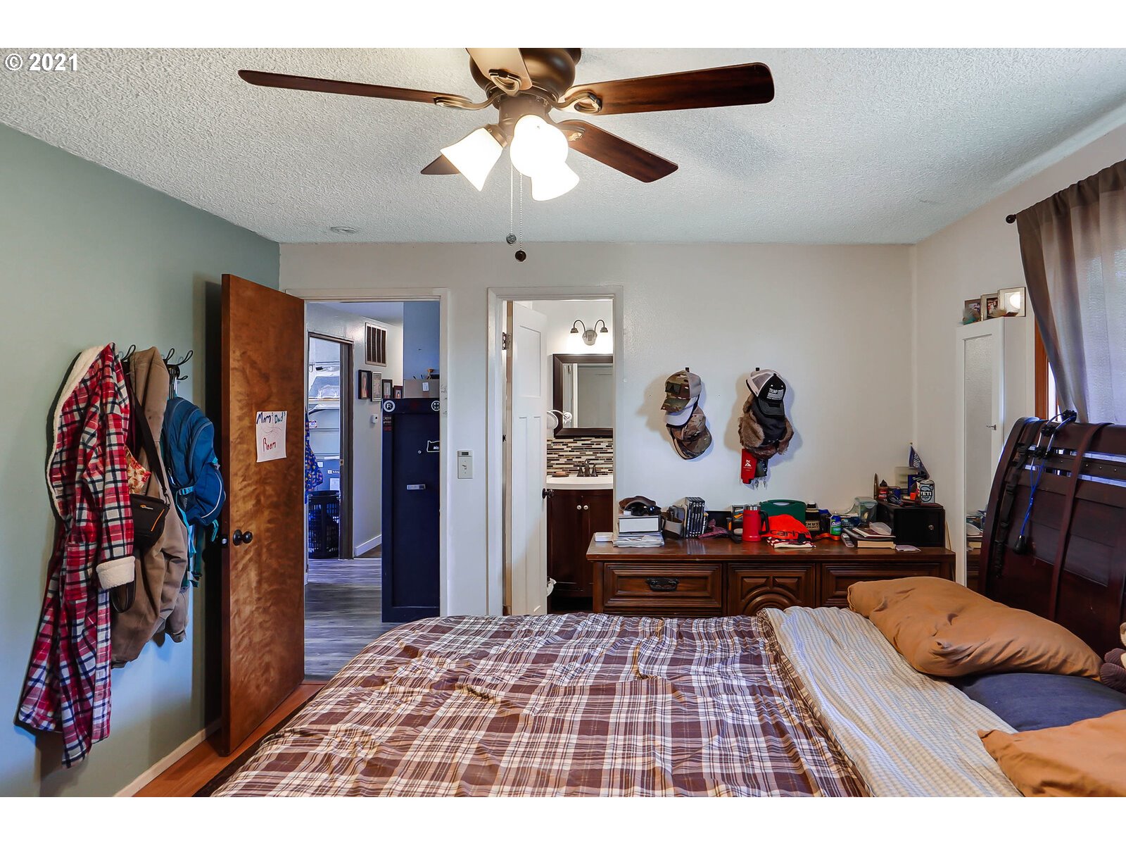 15145 Guthrie Road Dallas, OR 97338 - Photo 14 of 32 a bedroom with a bed and a chandelier