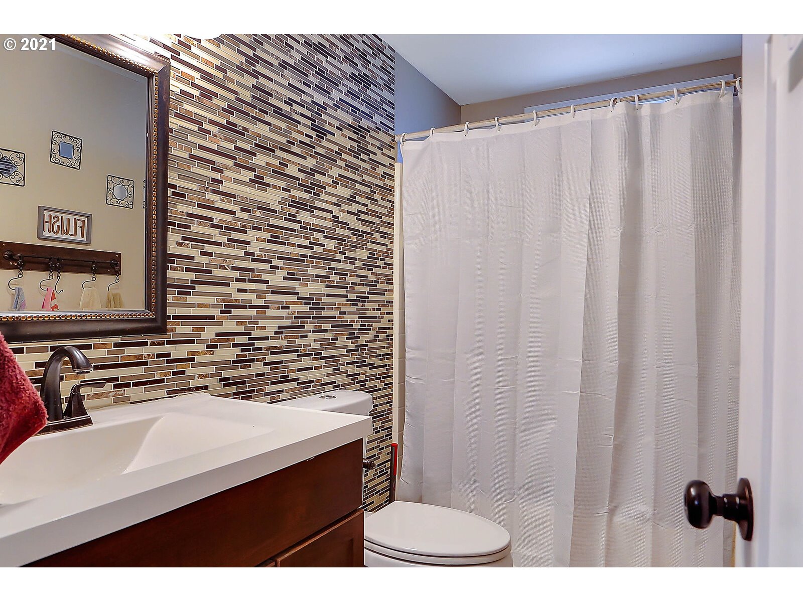 15145 Guthrie Road Dallas, OR 97338 - Photo 17 of 32 a bathroom with a sink a toilet and shower curtain