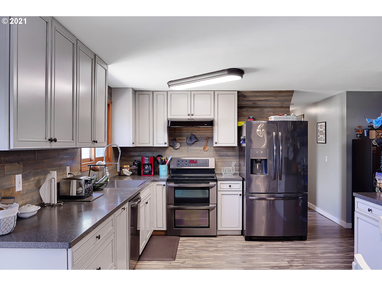 15145 Guthrie Road Dallas, OR 97338 - Photo 10 of 32 a kitchen with granite countertop a refrigerator and a sink