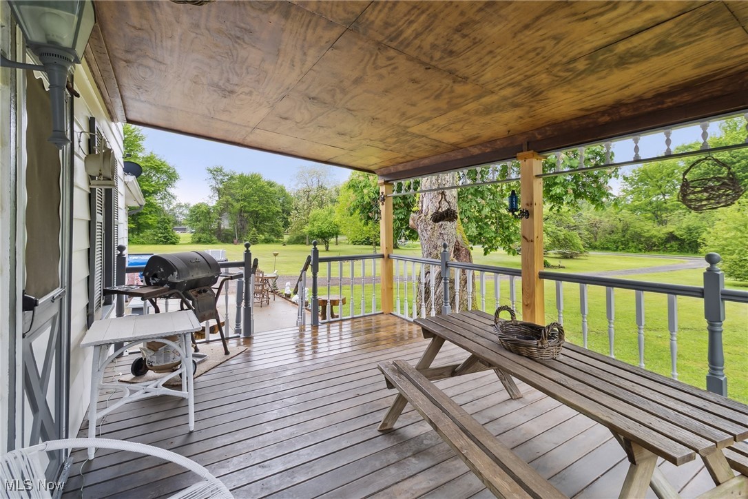 2860 Middle Road Pierpont, OH 44082 - Photo 5 of 50 Wooden deck featuring view of wooded area, a yard, and grilling area