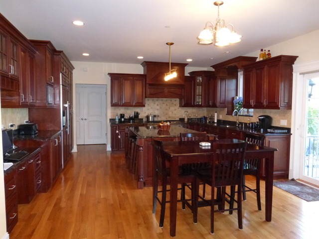 311 North Westgate Road Mount Prospect, IL 60056 - Photo 7 of 18 a kitchen with stainless steel appliances kitchen island granite countertop a stove a refrigerator a sink a dining table and chairs with wooden floor