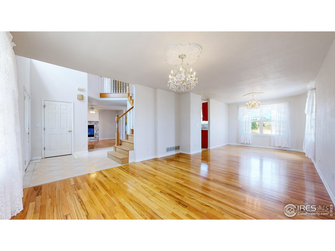 5306 Foothills Drive Berthoud, CO 80513 - Photo 12 of 40 a living room with a bed furniture and a chandelier