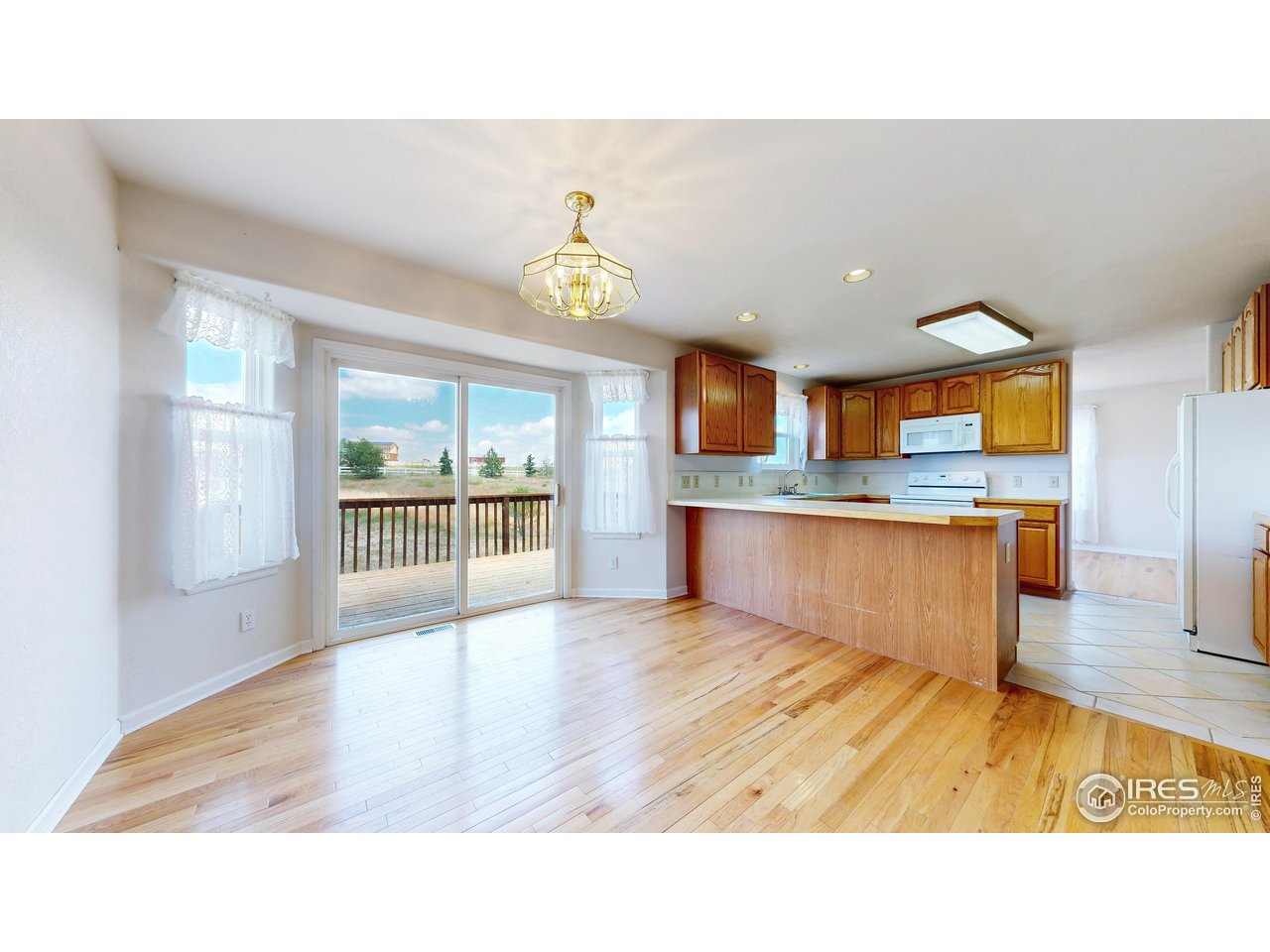 5306 Foothills Drive Berthoud, CO 80513 - Photo 17 of 40 a living room with stainless steel appliances kitchen island granite countertop a sink a counter space and a window