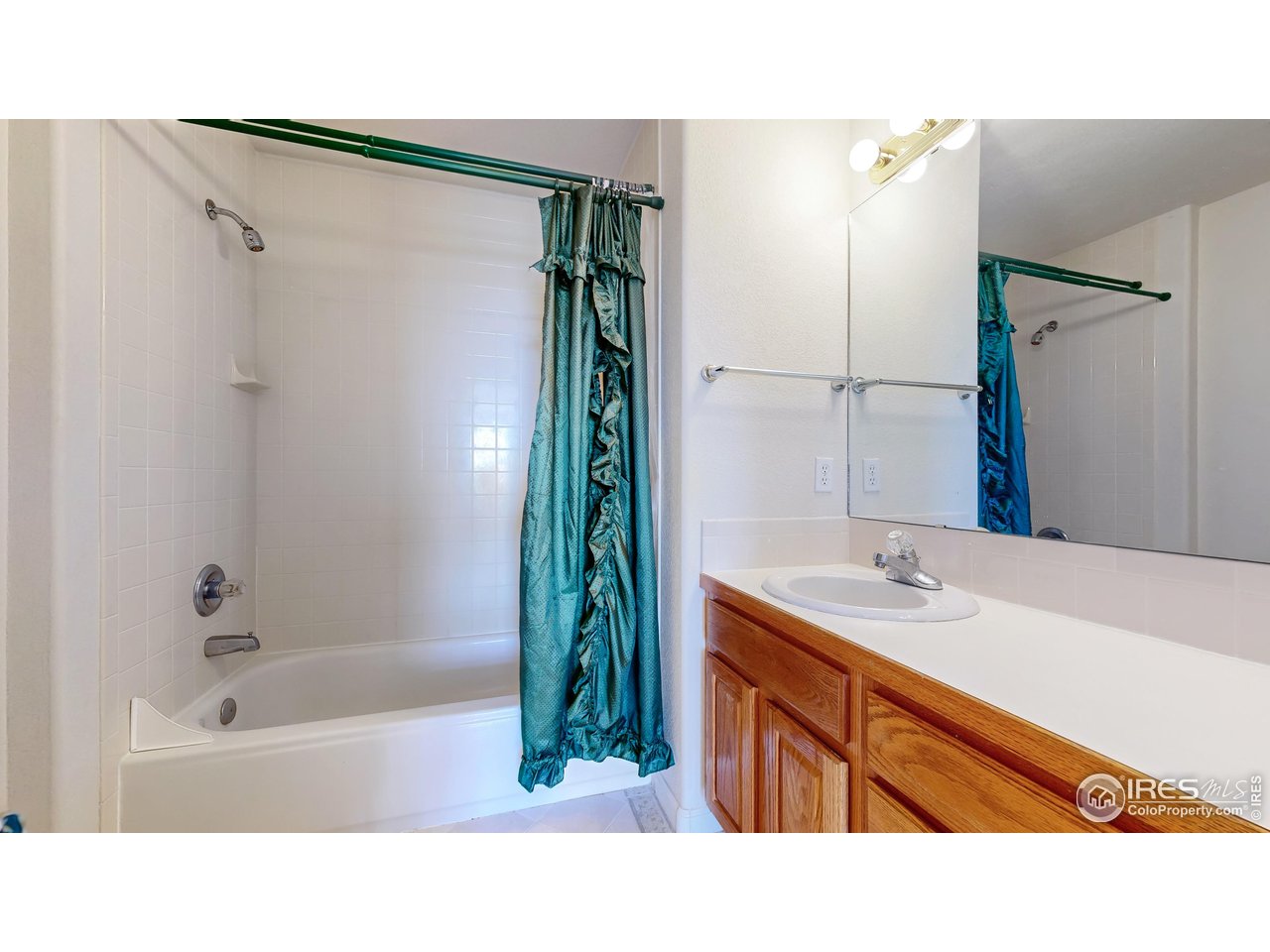 5306 Foothills Drive Berthoud, CO 80513 - Photo 34 of 40 a bathroom with a sink tub shower and a mirror