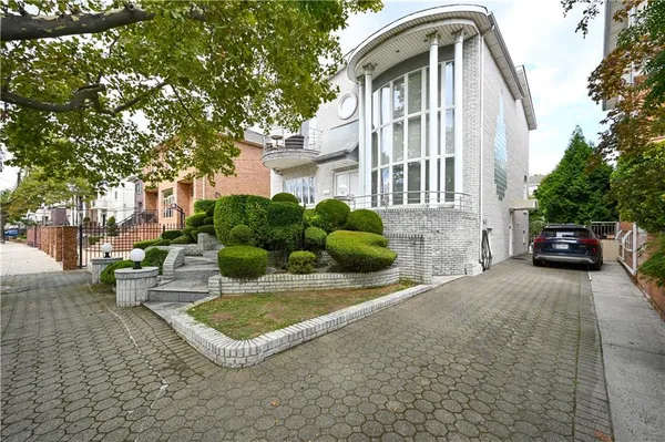 a front view of a house with a garden