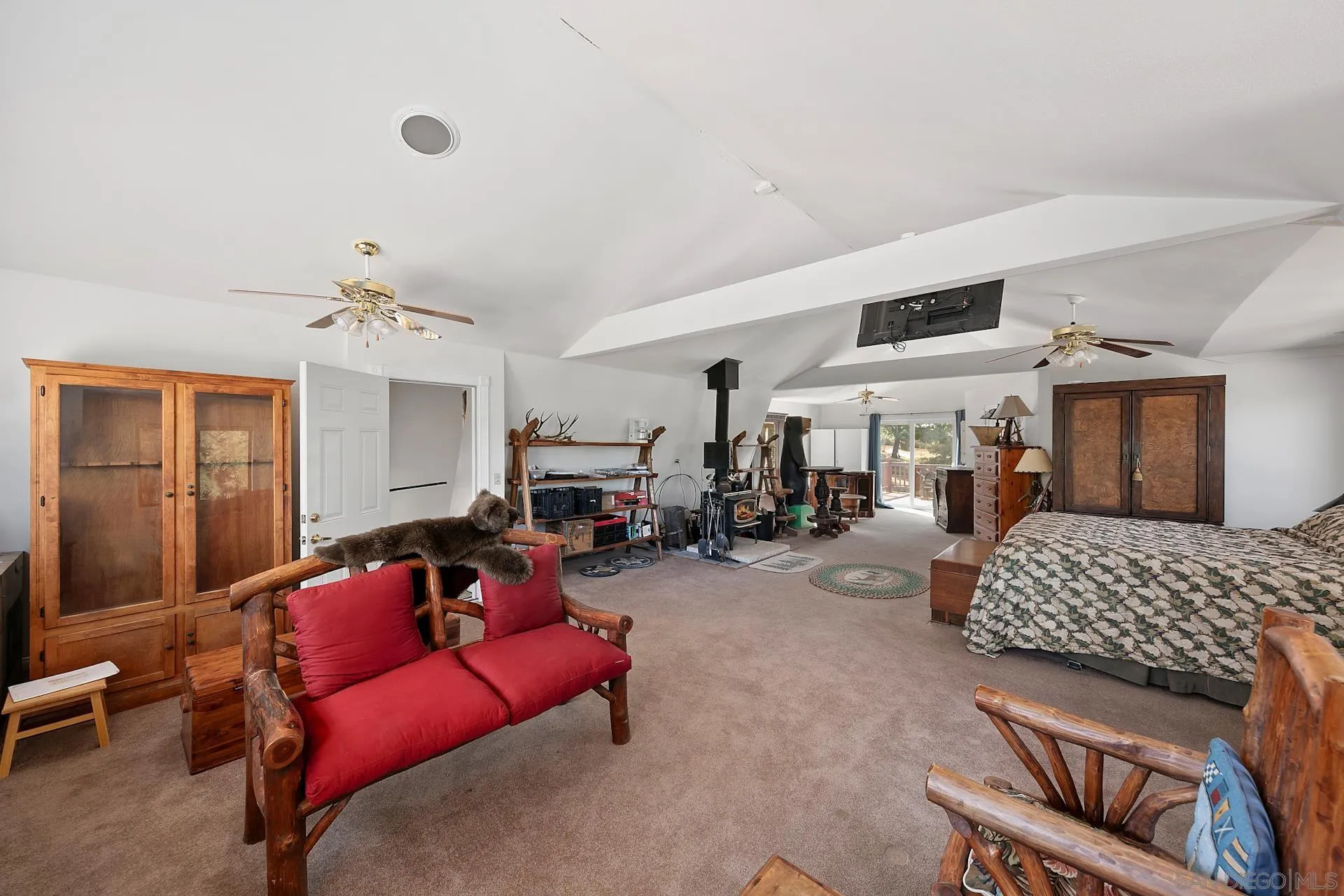 8203 Morris Ranch Road Pine Valley, CA 91962 - Photo 16 of 42 a bedroom with furniture and a chandelier