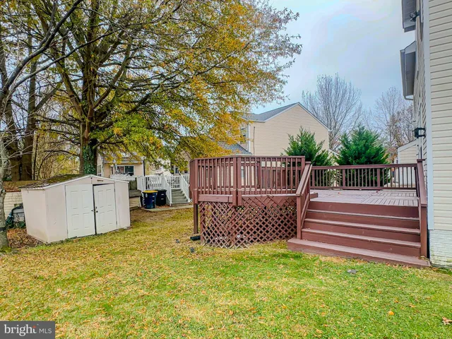 a view of a backyard with wooden fence