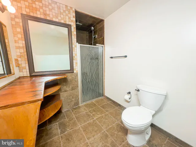 a bathroom with a toilet and a mirror