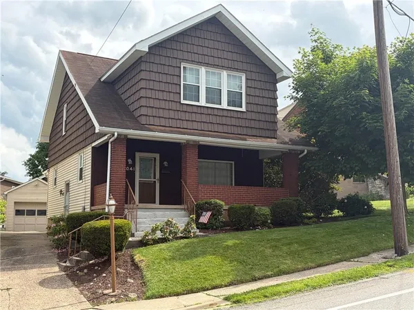 front view of a house with a yard