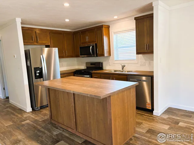a kitchen with stainless steel appliances a refrigerator and a sink