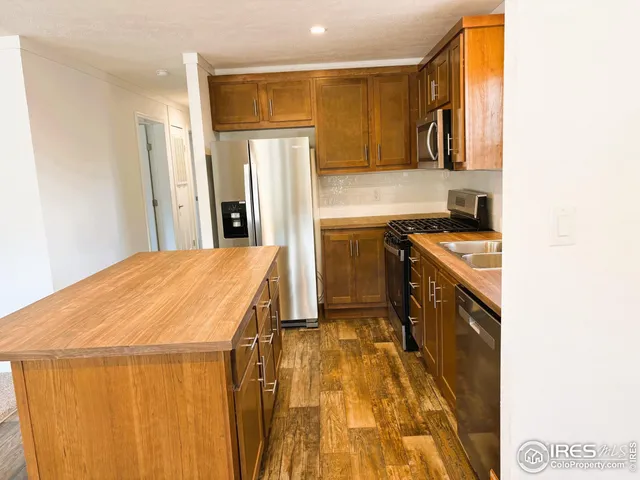 a kitchen with a sink appliances and cabinets