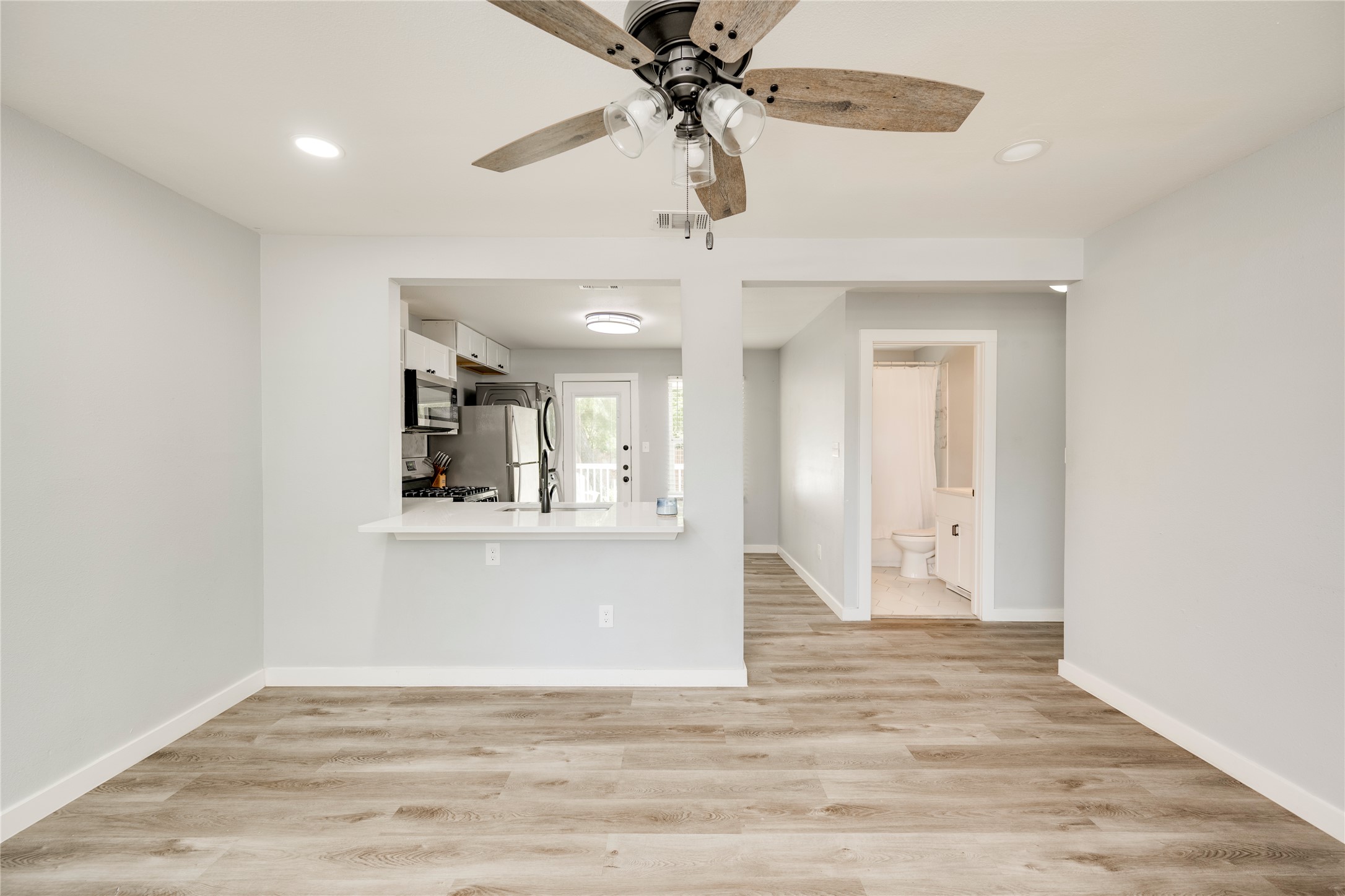 1400 Marcus Place, Unit B Austin, TX 78721 - Photo 39 of 39 An open floorplan seamlessly connects the living space to a well-appointed kitchen.