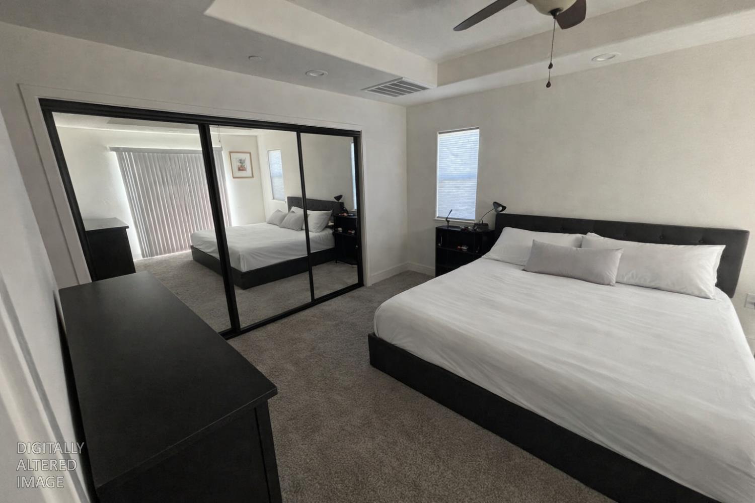 2481 Quail Hill Road Copperopolis, CA 95228 - Photo 11 of 23 a bedroom with a bed a mirror and a walk in closet