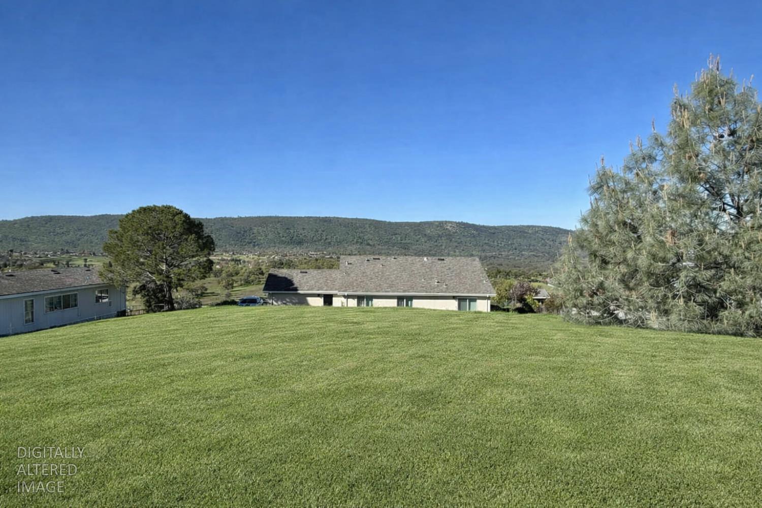 2481 Quail Hill Road Copperopolis, CA 95228 - Photo 20 of 23 a grassy field with a view of mountains in background