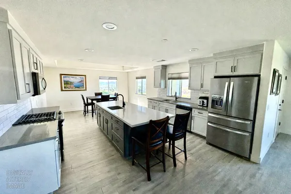 a large kitchen with a table and chairs