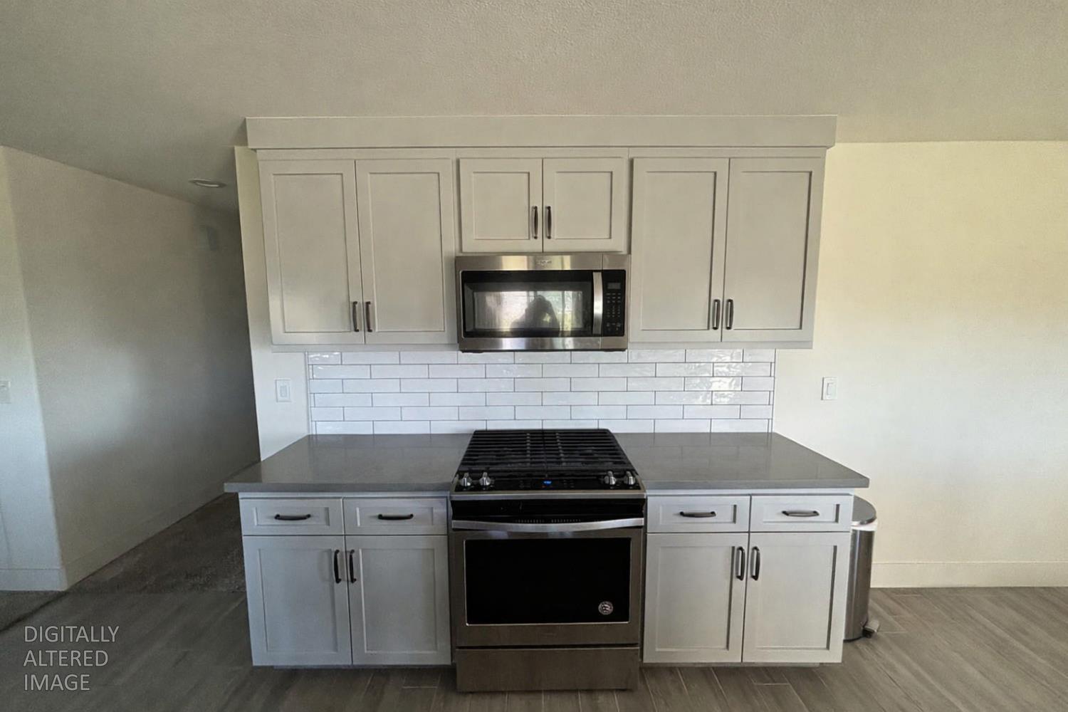 2481 Quail Hill Road Copperopolis, CA 95228 - Photo 4 of 23 a kitchen with white cabinets and black appliances