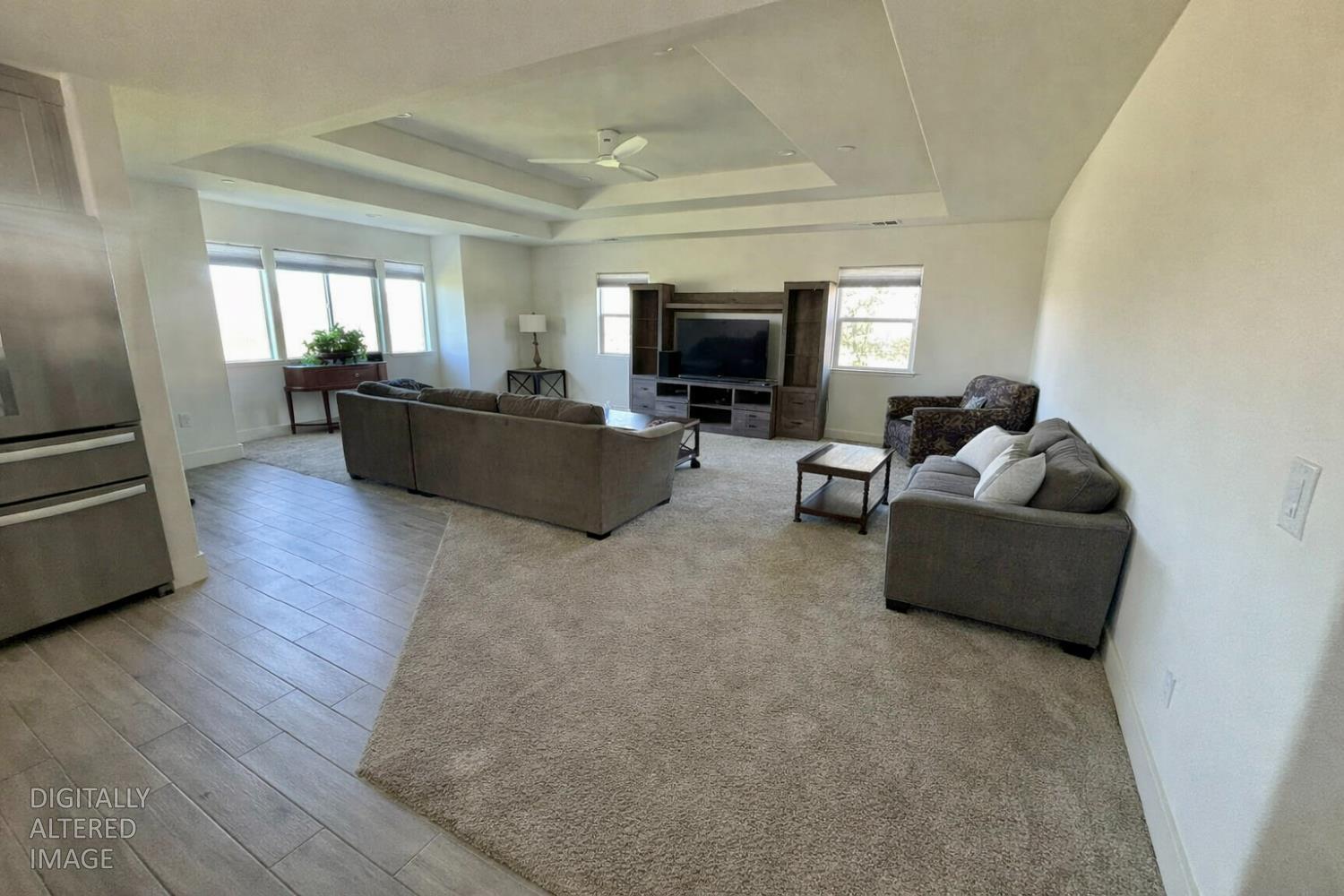 2481 Quail Hill Road Copperopolis, CA 95228 - Photo 7 of 23 a living room with furniture a flat screen tv and a fireplace