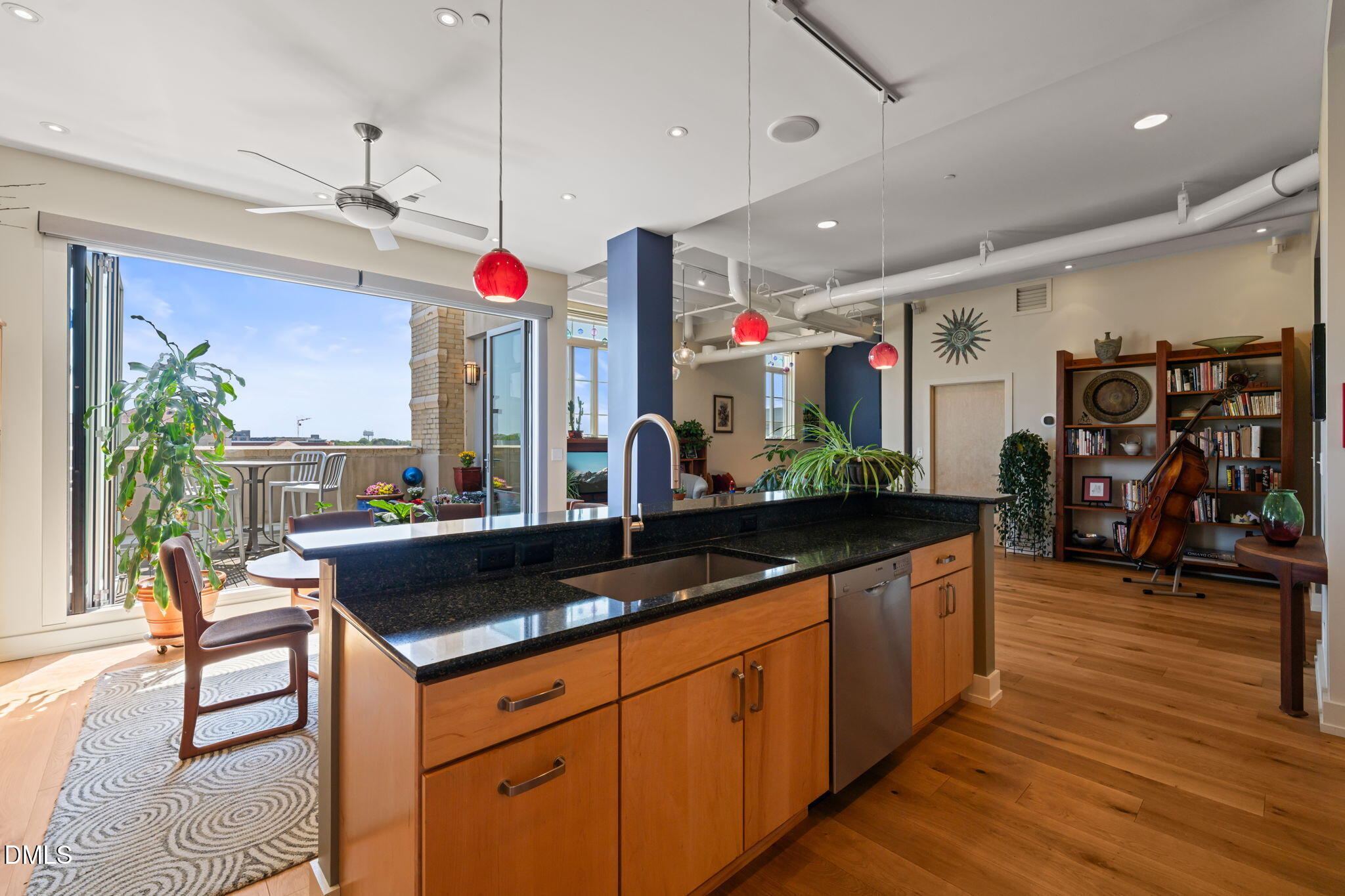 a kitchen that has a lot of cabinets and wooden floor